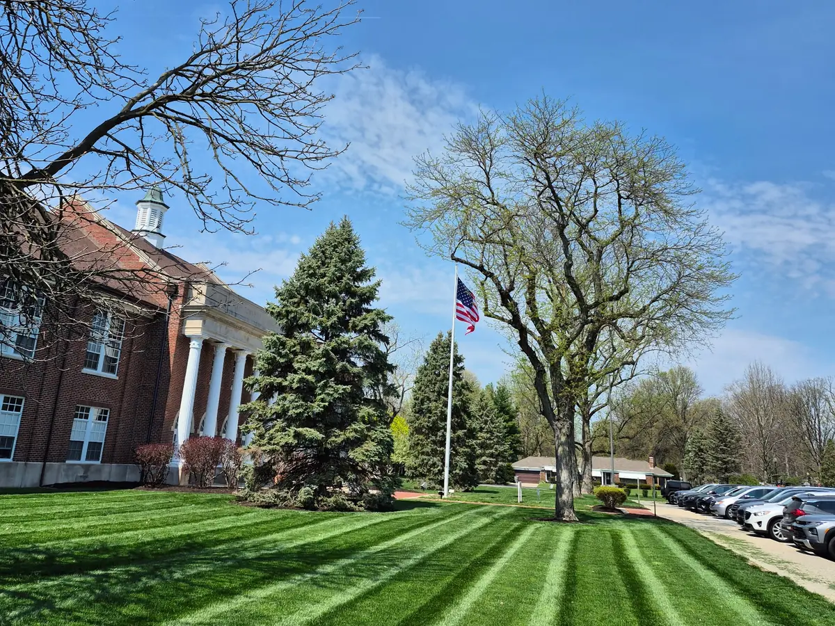 Freshly mowed and striped commercial lawn at an office property in Indianapolis, IN