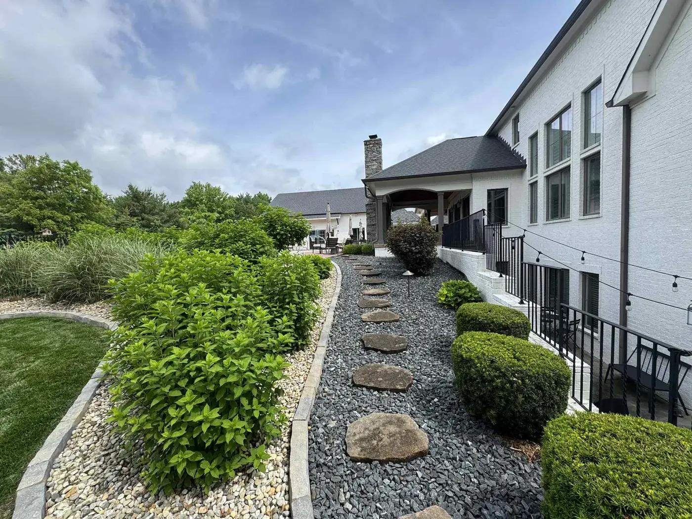 Terraced landscape beds and low retaining wall at a home in Indianapolis, IN