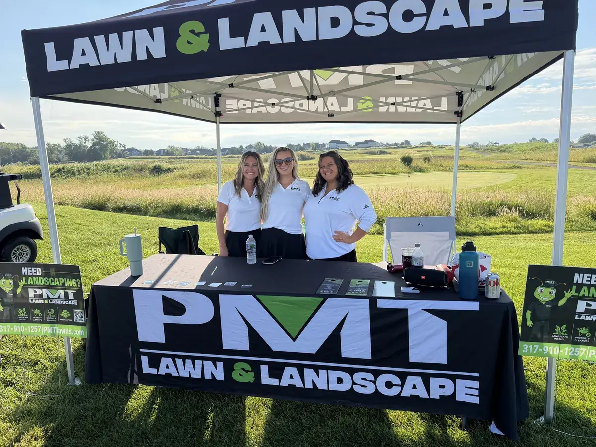 PMT Lawn & Landscape team at a community golf outing booth near Indianapolis, IN